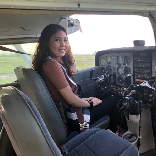 Emma flying a small plane during flight training