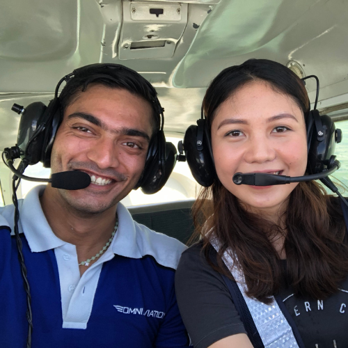 Emma with flight instructor inside cockpit