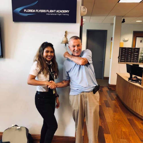 Emma posing after passing a flight exam